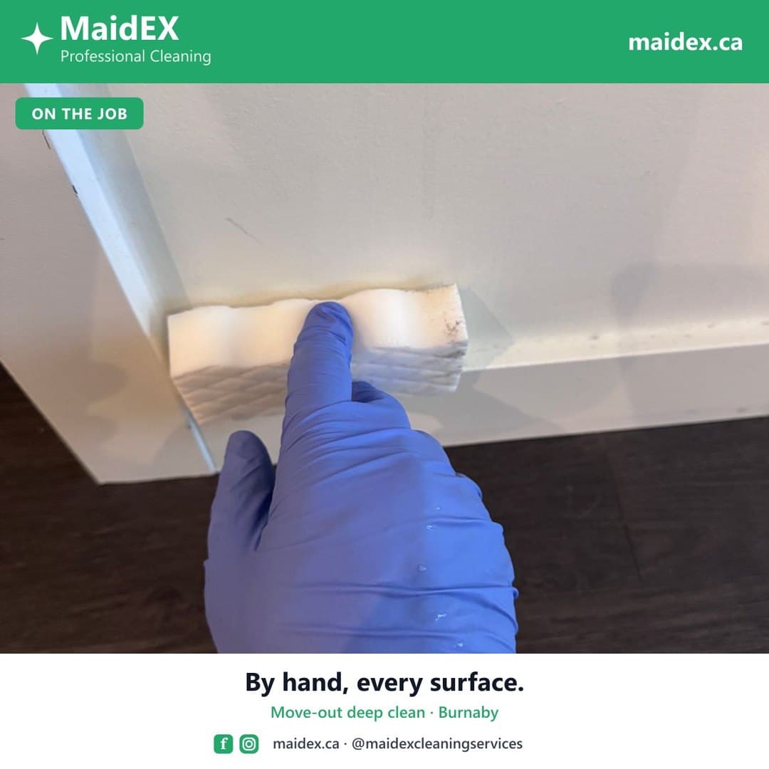 MaidEX cleaner wiping a surface by hand during a move-out deep clean in Burnaby